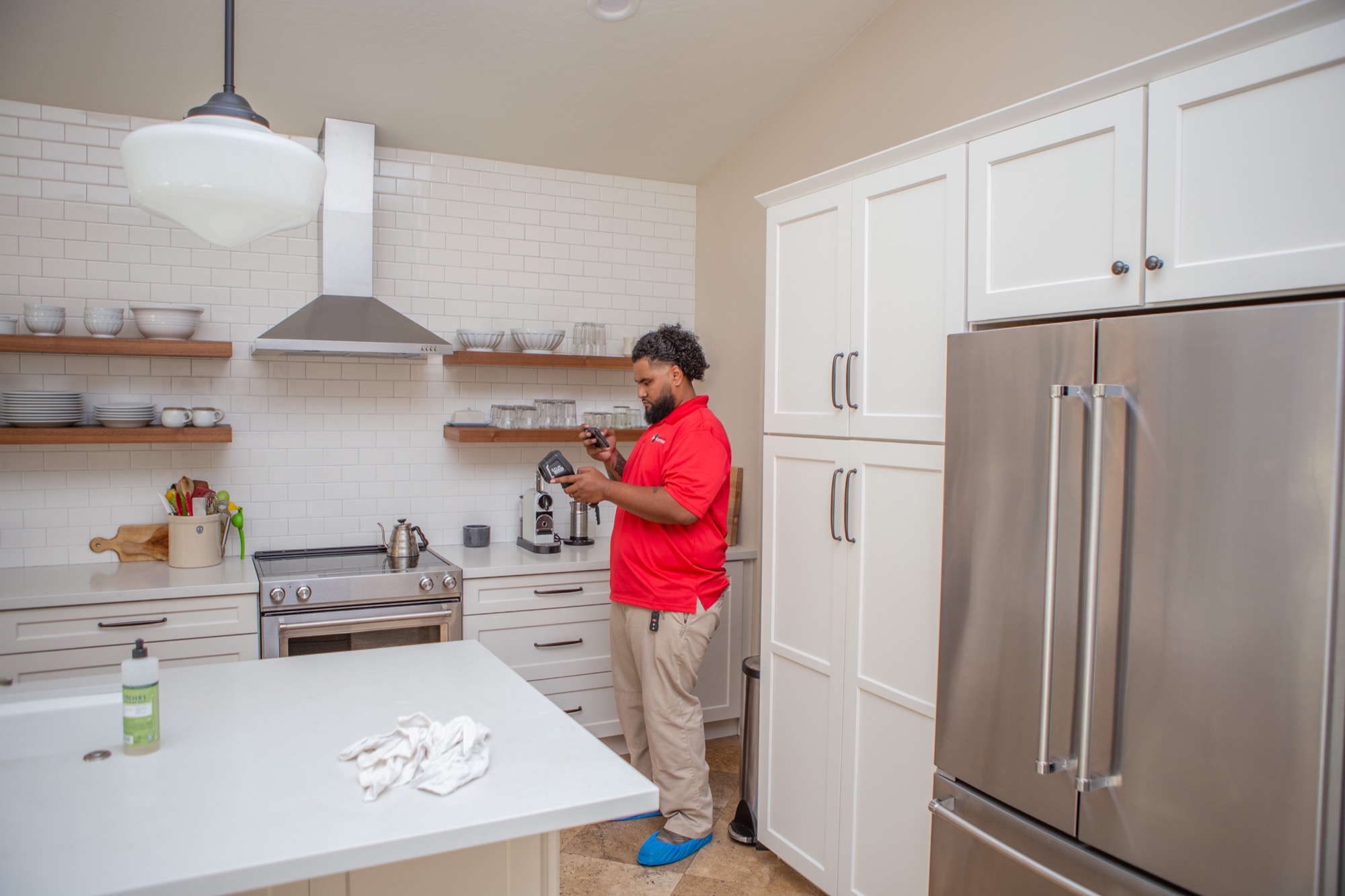 Technician checking moisture levels in a kitchen